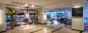 a lobby of a hotel with tables and chairs at DoubleTree Resort by Hilton Hotel Penang in Batu Ferringhi