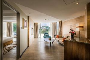 a living room with a couch and a table at DoubleTree Resort by Hilton Hotel Penang in Batu Ferringhi