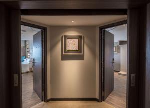 a hallway with two doors and a painting on the wall at DoubleTree Resort by Hilton Hotel Penang in Batu Ferringhi