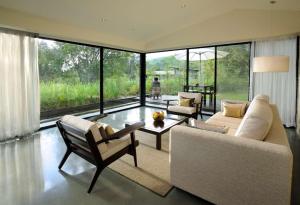 a living room with a couch and a table at Hilton Shillim Estate Retreat and Spa in Lonavala