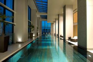 a hotel hallway with a swimming pool in a building at Conrad Tokyo in Tokyo