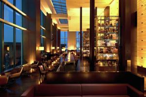 a lobby of a hotel with a bar at Conrad Tokyo in Tokyo
