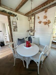 a white table and chairs in a room at Pittelille - supercozy small luxury in Henningsvær in Henningsvær +13 photos