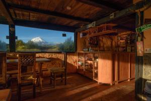 a room with a table and a view of a mountain at MAUCA PEDREGAL in Machachi