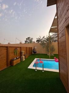 a backyard with a swimming pool and green grass at Cielo Beach Resort 