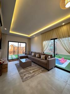 a living room with a couch and a large window at Cielo Beach Resort in Al Qaryah +59 photos