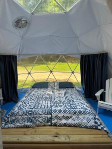 a large bed in a canvas tent with a bed sidx sidx sidx at Harmony Tree Resorts inc in Nashville