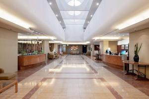 a large lobby with a long hallway with aospital at DoubleTree by Hilton Esplanade Darwin in Darwin