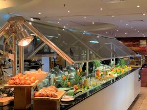 a buffet line with fruits and vegetables on display at DoubleTree by Hilton Esplanade Darwin in Darwin