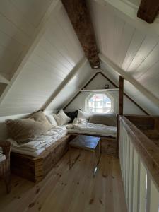 a room with two beds in a attic at Pittelille - supercozy small luxury in Henningsvær in Henningsvær