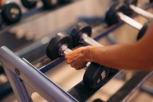 a person is pointing at a row of push buttons at Hotel La Croix in Honolulu