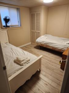a bedroom with two beds and a window and a window at Economical Homestay in Burnaby