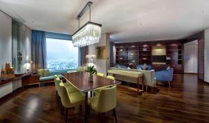 a dining room and living room with a table and chairs at Hilton Da Nang in Da Nang