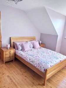 a bedroom with a bed and two night stands at 46 Dunalinn in Culdaff