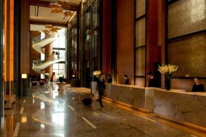 a person walking through a lobby of a building at Conrad Seoul in Seoul