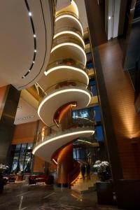 a building with a spiral staircase in a lobby at Conrad Seoul in Seoul