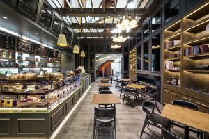 a restaurant with tables and chairs and a bakery at Conrad Seoul in Seoul