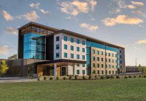 a large white building with blue windows at Doubletree By Hilton Karaka in Auckland