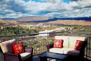 two chairs and a table on a balcony with a view at Historic Clarkdale apartment #104 in Clarkdale