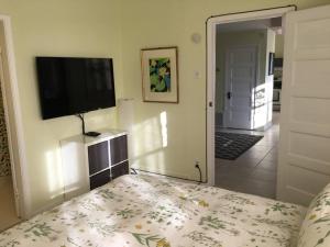 a bedroom with a bed and a flat screen tv at Historic Clarkdale apartment #104 in Clarkdale