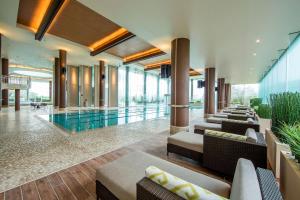 a hotel lobby with a swimming pool and chairs at Hilton Odawara Resort & Spa in Odawara