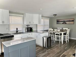 a kitchen with white cabinets and a table and chairs at Riverfront House in Harpers Ferry in Harpers Ferry