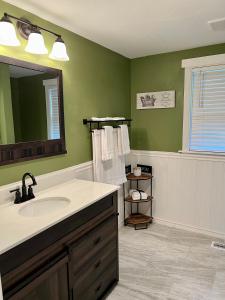 a bathroom with a sink and a mirror at Riverfront House in Harpers Ferry in Harpers Ferry