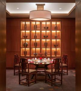 a dining room with a table and chairs at Conrad Bangkok in Bangkok +37 photos