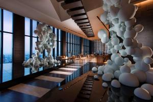 a lobby with white balloons on the wall at Conrad Osaka in Osaka