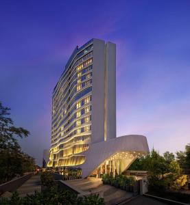 a tall building with a lit up facade at DoubleTree by Hilton Ahmedabad in Ahmedabad