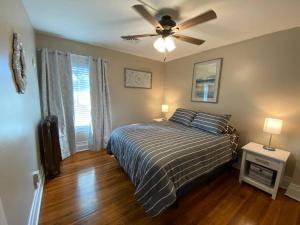 a bedroom with a bed and a ceiling fan at Beautifully remodeled house 1.5 miles from falls. in Niagara Falls