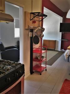 a kitchen with a stove and a red cart in it at Studio 203 in Clarkdale