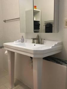 a bathroom with a white sink and a mirror at Studio 203 in Clarkdale