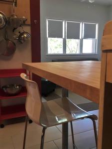 a wooden table and a chair in a kitchen at Studio 203 in Clarkdale