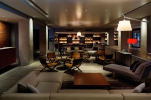 a living room with a couch and chairs and a bar at Kyukaruizawa Kikyo, Curio Collection by Hilton in Karuizawa