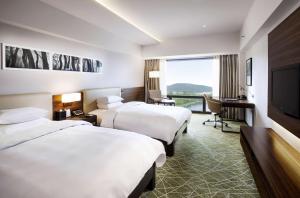 Postel nebo postele na pokoji v ubytování Hilton Gyeongju