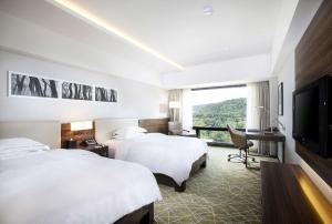 Postel nebo postele na pokoji v ubytování Hilton Gyeongju