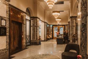 a lobby of a building with chairs and people at Doubletree By Hilton Wellington in Wellington