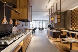 a kitchen with two chefs preparing food in a restaurant at Hilton Nagasaki in Nagasaki