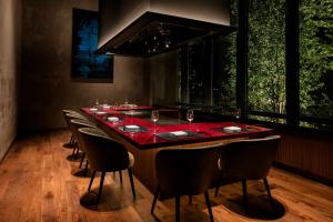 a long table with chairs and a red table cloth at Hilton Nagasaki in Nagasaki