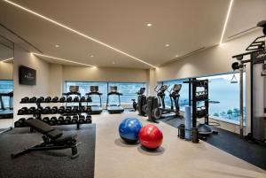 a gym with exercise equipment and a view of the ocean at Hilton Nagasaki in Nagasaki
