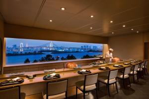 a long table in a room with a large wall mural at Hilton Tokyo Odaiba in Tokyo