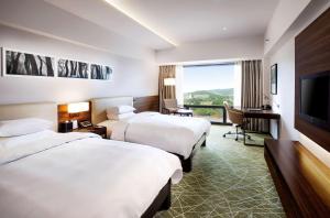 Postel nebo postele na pokoji v ubytování Hilton Gyeongju