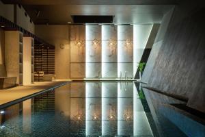 a swimming pool in a building with a wall at Hilton Aberdeen TECA in Aberdeen