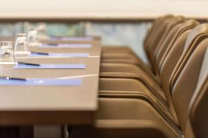 a row of tables and chairs on a bus at Hilton Aberdeen TECA in Aberdeen