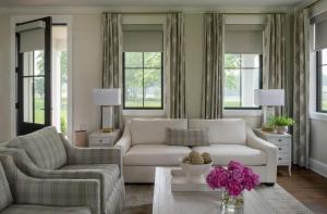 a living room with two couches and a table at The Oaks Waterfront in Saint Michaels