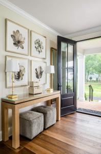 a living room with a desk and a table with two lamps at The Oaks Waterfront in Saint Michaels