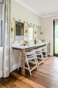 a bathroom with a vanity with two sinks and two mirrors at The Oaks Waterfront in Saint Michaels