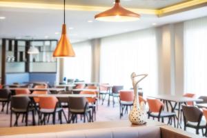 a dining room with tables and chairs at Hampton By Hilton Aberdeen Westhill in Westhill 