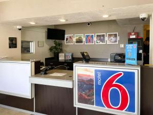 an office with a desk with a sign on it at Motel 6 Cheyenne in Cheyenne
